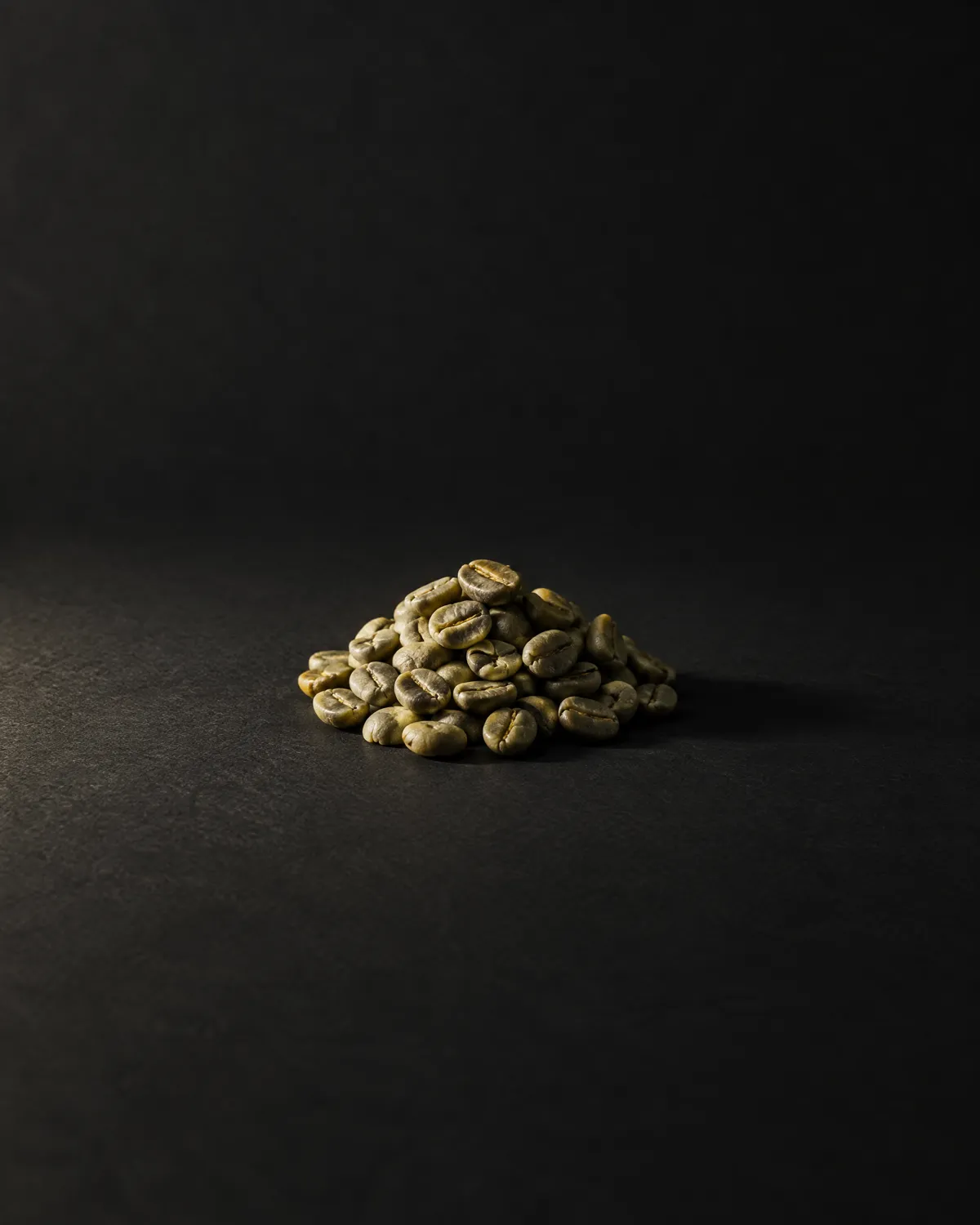 A mound of green unroasted coffee beans