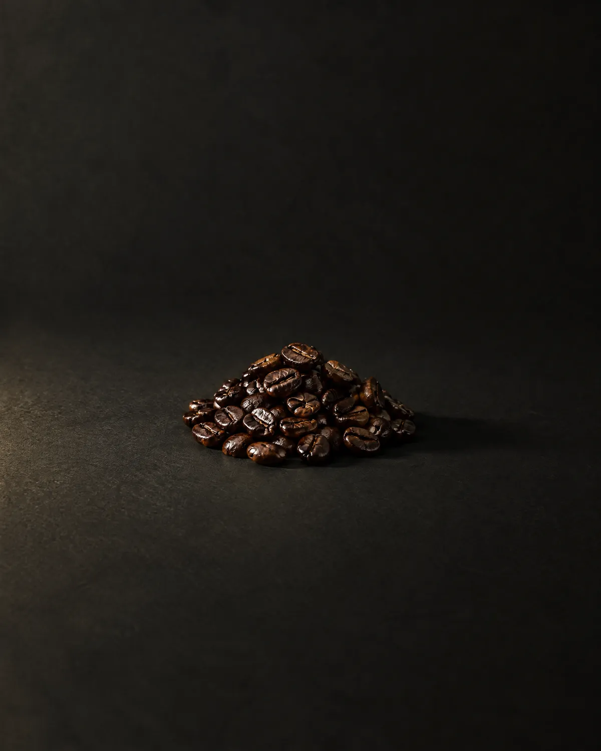 A mound of dark roasted coffee beans
